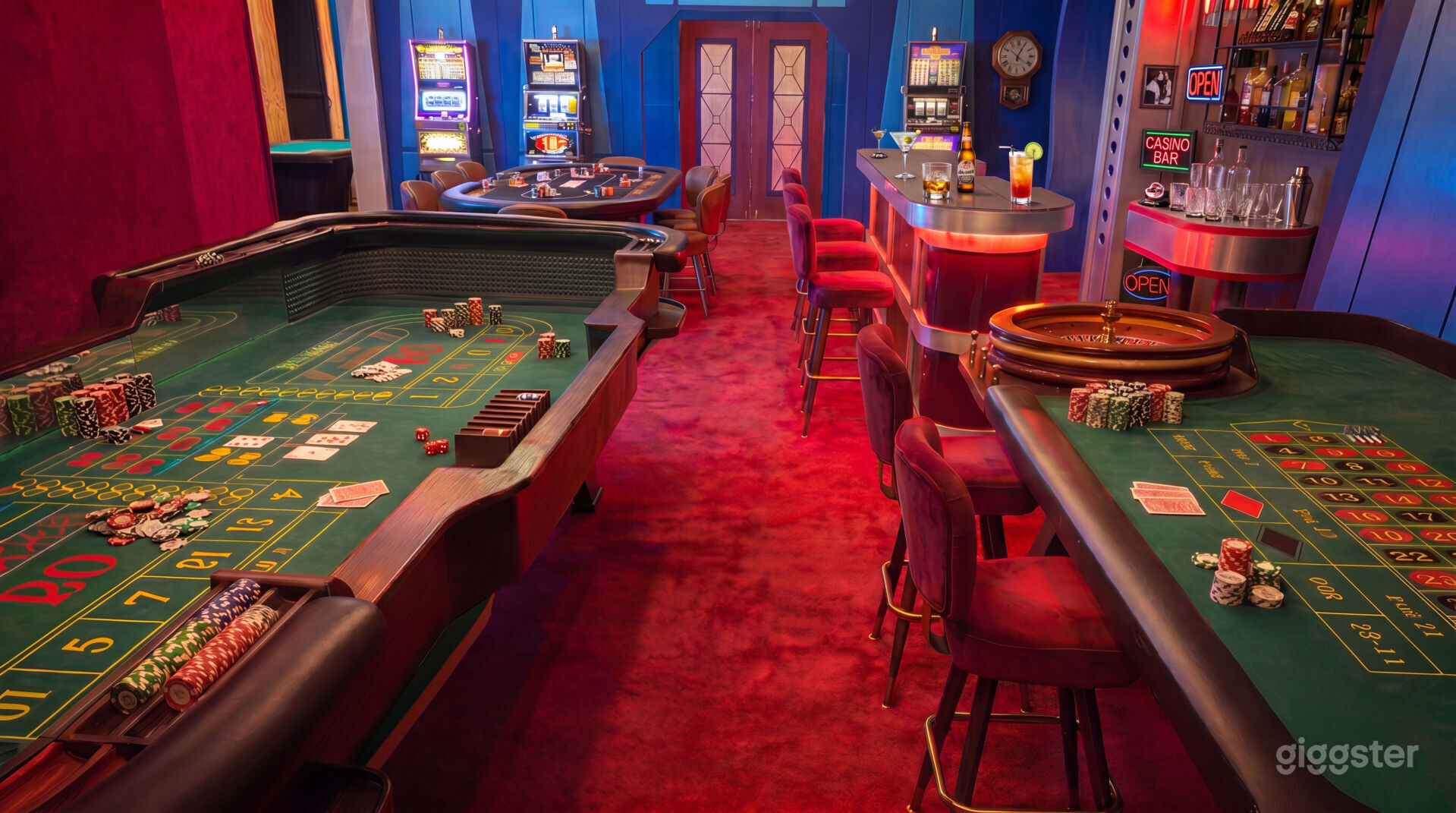 The Casino - red-carpet gaming floor, gaming tables, backlit luxury bar, velvet drapery
